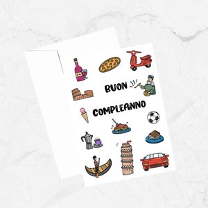 May include: A white card with colorful illustrations of Italian icons, including a pizza, a scooter, the Colosseum, a gondola, the Leaning Tower of Pisa, and a glass of wine. The text "BUON COMPLEANNO" is written in black at the top of the card.