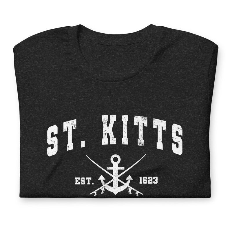 May include: Black t-shirt with white text that reads "ST. KITTS EST. 1623" with a white anchor and crossed fishing rods underneath.