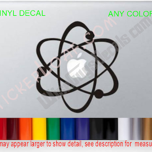May include: Black vinyl decal featuring an atom design with an Apple logo at the center. The words "VINYL DECAL" and "ANY COLOR" are in green. A color chart is shown at the bottom. The text "Decals may appear larger to show detail, see description for measurements" is also present.