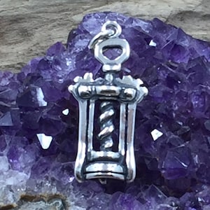 May include: Silver corkscrew charm pendant. The charm is detailed with a corkscrew design and a loop for attaching to a necklace or bracelet.