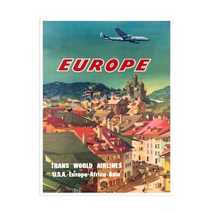 May include: Vintage travel poster advertising Trans World Airlines flights to Europe. The poster features a blue and white airplane flying over a colorful cityscape with red rooftops and a castle in the background. The text "EUROPE" is in large red letters at the top of the poster. The airline's name and destinations are listed at the bottom: "TRANS WORLD AIRLINES U.S.A. - Europe - Africa - Asia."