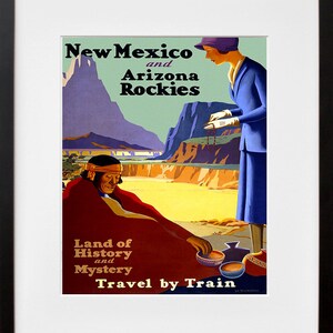 May include: Vintage travel poster advertising a trip to New Mexico and Arizona. The poster features a colorful illustration of a Native American man and a woman in a blue dress. The text reads "New Mexico and Arizona Rockies, Land of History and Mystery, Travel by Train".