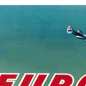 May include: A vintage TWA airline poster featuring a silver airplane flying against a blue sky. The text "EUROPE" is in red letters at the bottom of the poster.