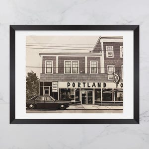 May include: A black and white photo of a storefront with the text "PORTLAND" above the entrance. The storefront has a sign that says "Gold, Bond, Stamps". A vintage car is parked in front of the store.