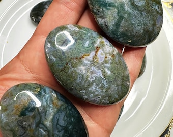 May include: Three green, white, and brown agate palm stones. The stones are smooth and polished, with a variety of patterns and swirls.