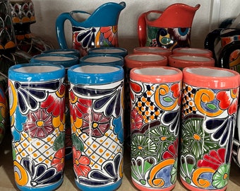 May include: A set of colorful ceramic mugs with floral designs. The mugs have blue, red, green, yellow, and white accents. The mugs are perfect for serving beverages like coffee, tea, or hot chocolate.