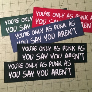 May include: Four fabric patches with the text "You're only as punk as you say you aren't" in white lettering. The patches are in different colors: green, red, blue, and black.