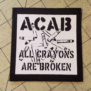 May include: Black and white patch with the text "ACAB" and "ALL CRAYONS ARE BROKEN" with a design of broken crayons in the background.