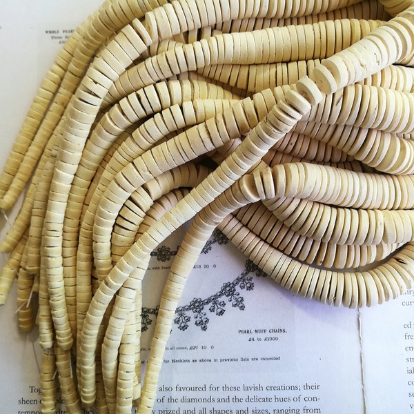 White color, graduated coconut heishi beads, 6mm to 15mm to 6mm. full strand 16 inch