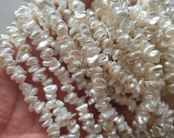 100 plus beads, nature shell chip beads coated with pearl finish, mostly 8 to 10mm, 15.5 inch