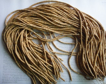 Old beads, natural sunbathed tan color 4 mm coconut heishi beads, 24" strand long.