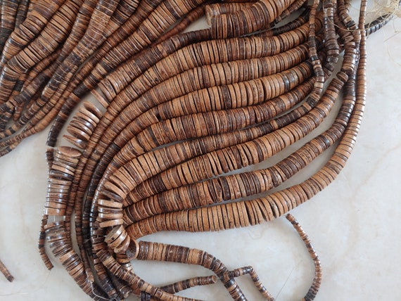 graduated coconut heishi beads, from 5mm to 20mm then to 5mm. full strand 19 inch