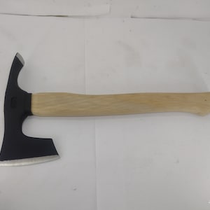 May include: A black axe with a wooden handle. The axe has a curved blade and a sharp edge.