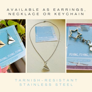 May include: Three silver paper airplane charms on cards. The charms are available as earrings, a necklace, or a keychain. The cards have the text "Flying, Flying, Flying" and "LilyfieldCreations.com". The charms are made of tarnish-resistant stainless steel.