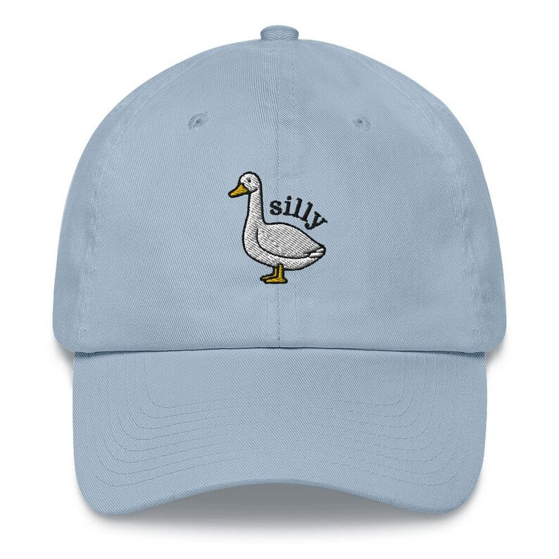 May include: A light blue baseball cap with an embroidered white duck and the word "silly" in black text.