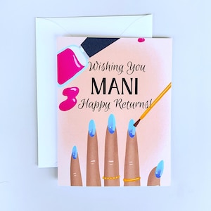 May include: A greeting card with a light pink background featuring an illustration of fingers with blue manicured nails, a bottle of hot pink nail polish, and a brush. The text reads: Wishing You MANI Happy Returns! A white envelope is behind the card.