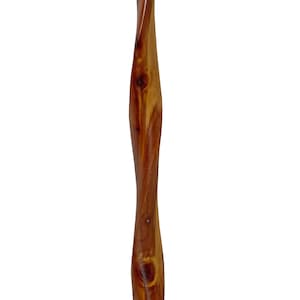 May include: A tall, wooden, decorative item with a twisted design. The wood is a warm brown color with visible knots and grain patterns. The item has a smooth, polished finish and is set against a white background.