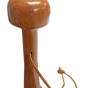 May include: A wooden walking cane with a rounded top and a smooth, polished finish. The cane is a warm brown color and features a leather wrist strap. The design is simple and classic, suitable for everyday use.