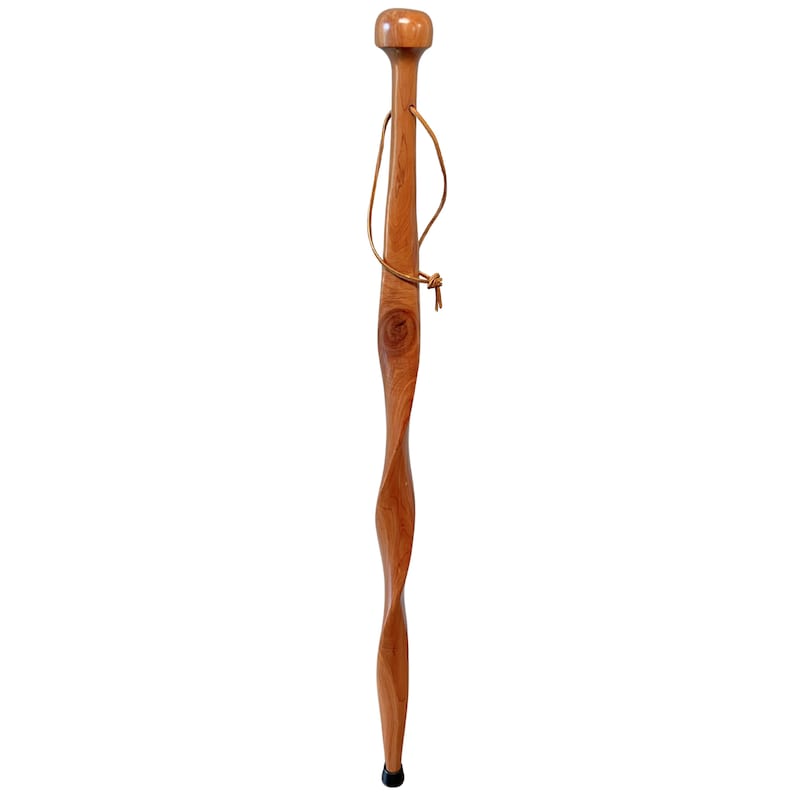May include: A wooden walking stick with a twisted design. The stick is made of light brown wood and has a rounded top and a black rubber tip. A leather strap is attached near the top.