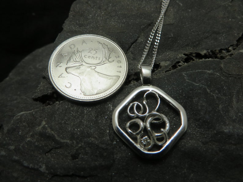 sterling silver pendant set with a diamond on white gold claws