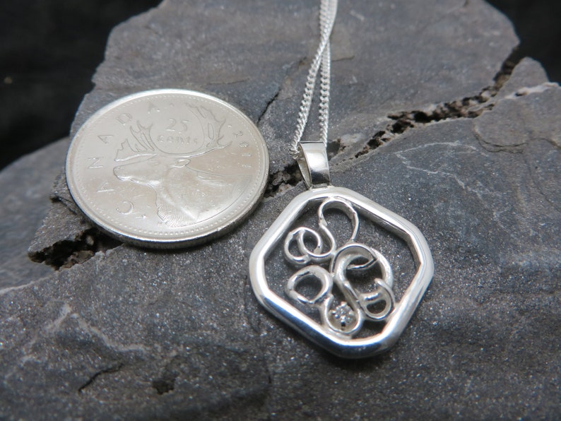 sterling silver pendant set with a diamond on white gold claws
