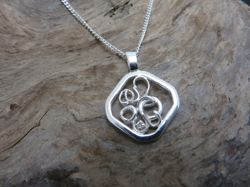 sterling silver pendant set with a diamond on white gold claws