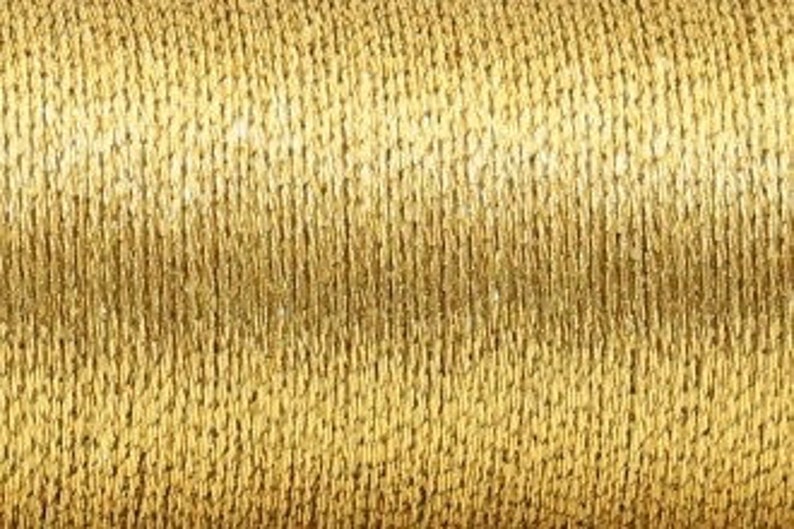 May include: A spool of gold metallic thread.