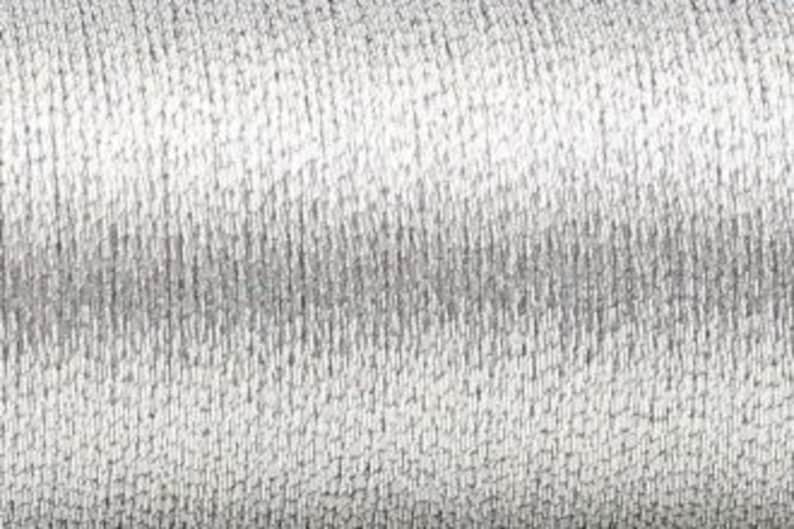 May include: A spool of silver metallic thread.