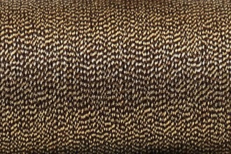 May include: Close-up of a brown and beige textured fabric with a subtle wave pattern.