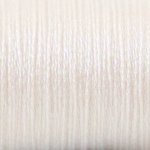 May include: Close-up of white thread with a subtle sheen.