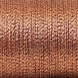 May include: A close-up of a spool of brown and beige yarn. The yarn is textured and has a subtle sheen.