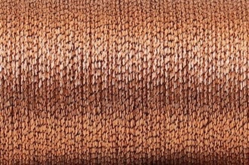 May include: A close-up of a spool of brown and beige yarn. The yarn is textured and has a subtle sheen.