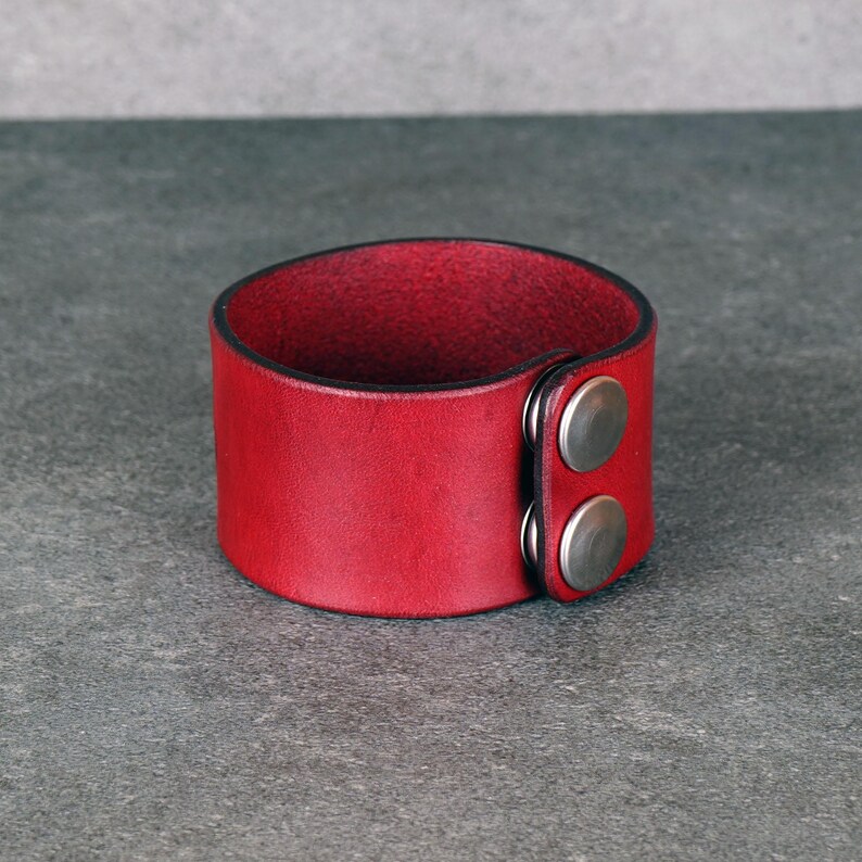 Handmade leather bracelet with dragon engraving.