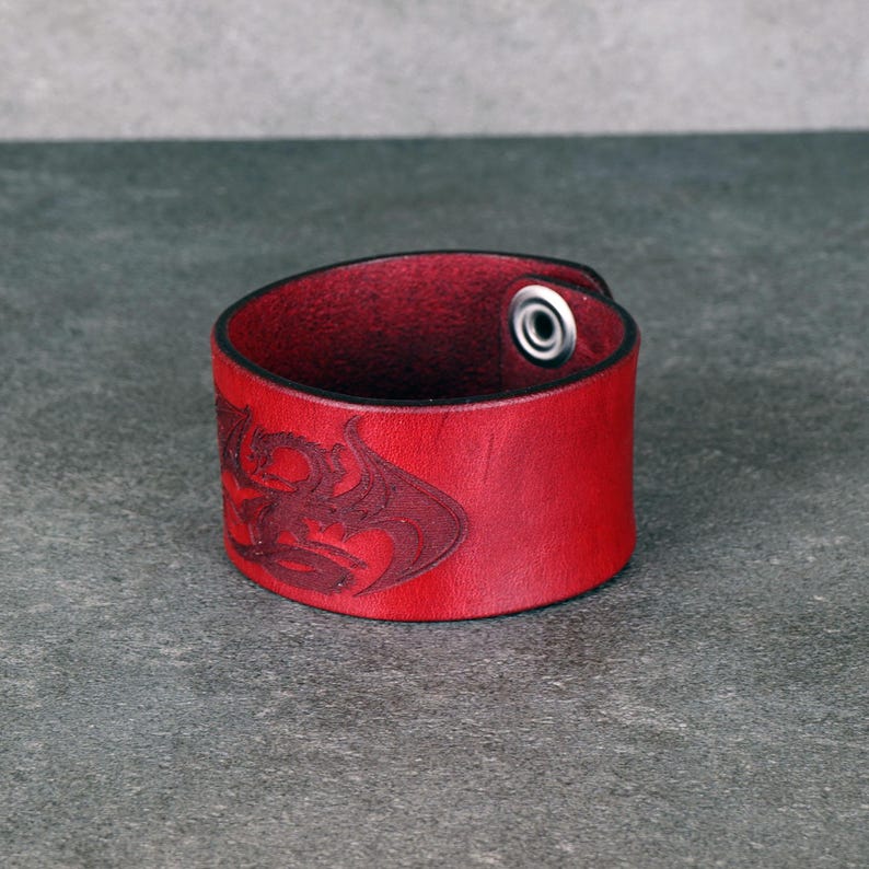 Handmade leather bracelet with dragon engraving.