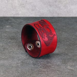 Handmade leather bracelet with dragon engraving.