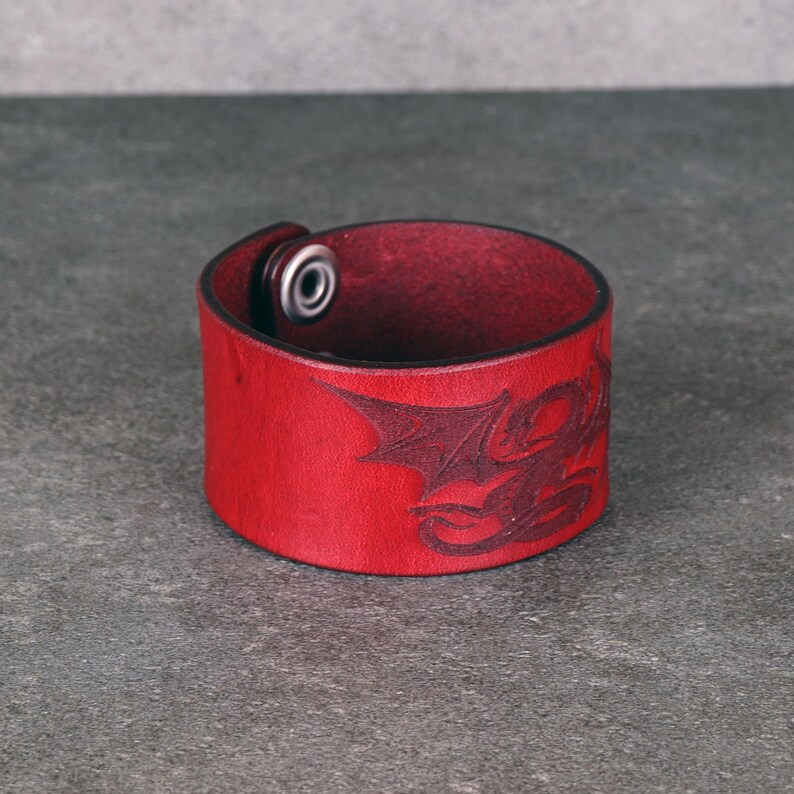 Handmade leather bracelet with dragon engraving.