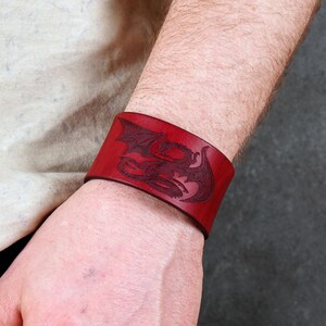 Handmade leather bracelet with dragon engraving.