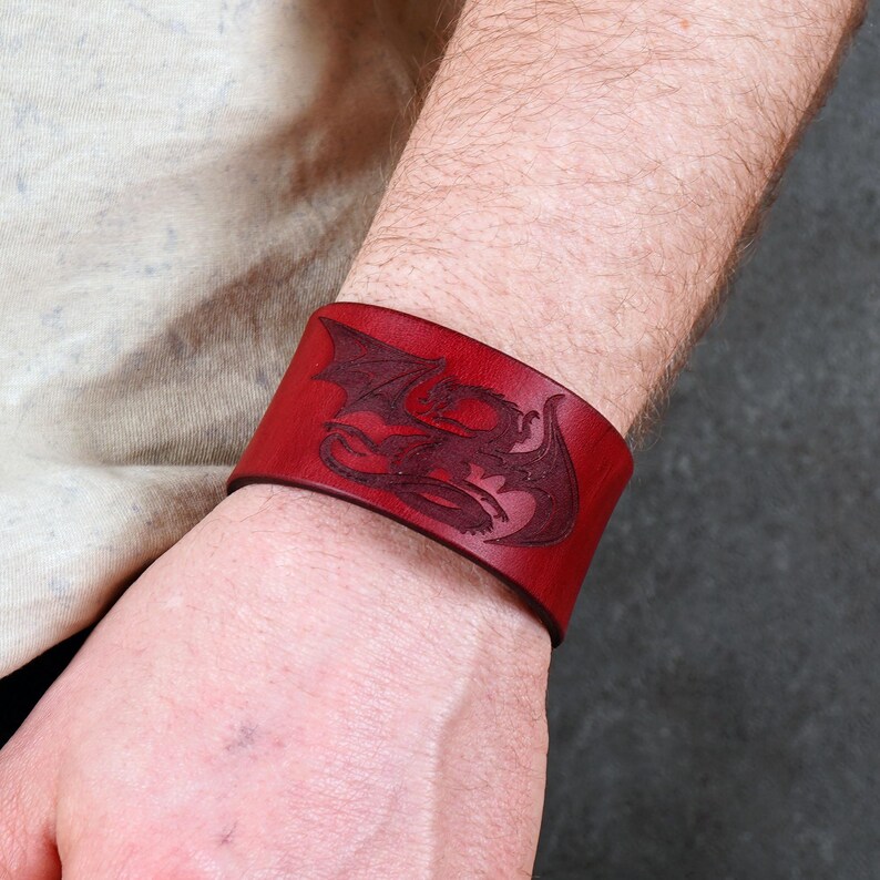 Handmade leather bracelet with dragon engraving.