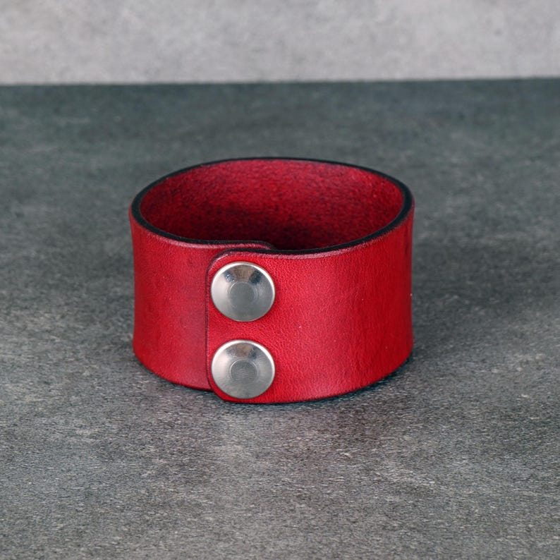 Handmade leather bracelet with dragon engraving.