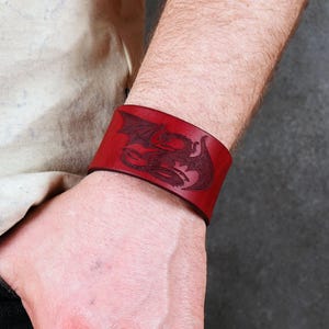 Handmade leather bracelet with dragon engraving.