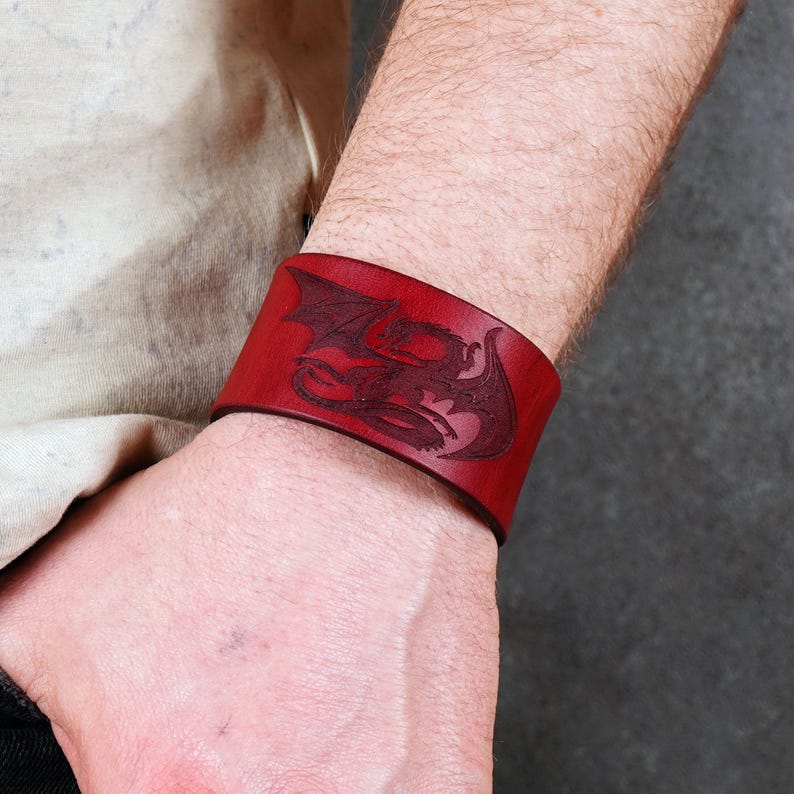 Handmade leather bracelet with dragon engraving.