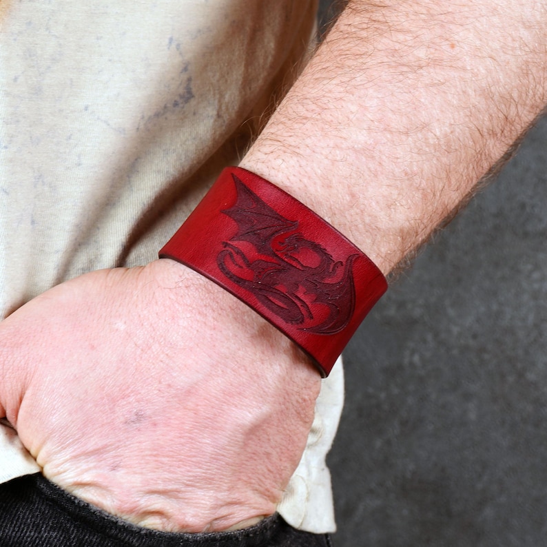 Handmade leather bracelet with dragon engraving.