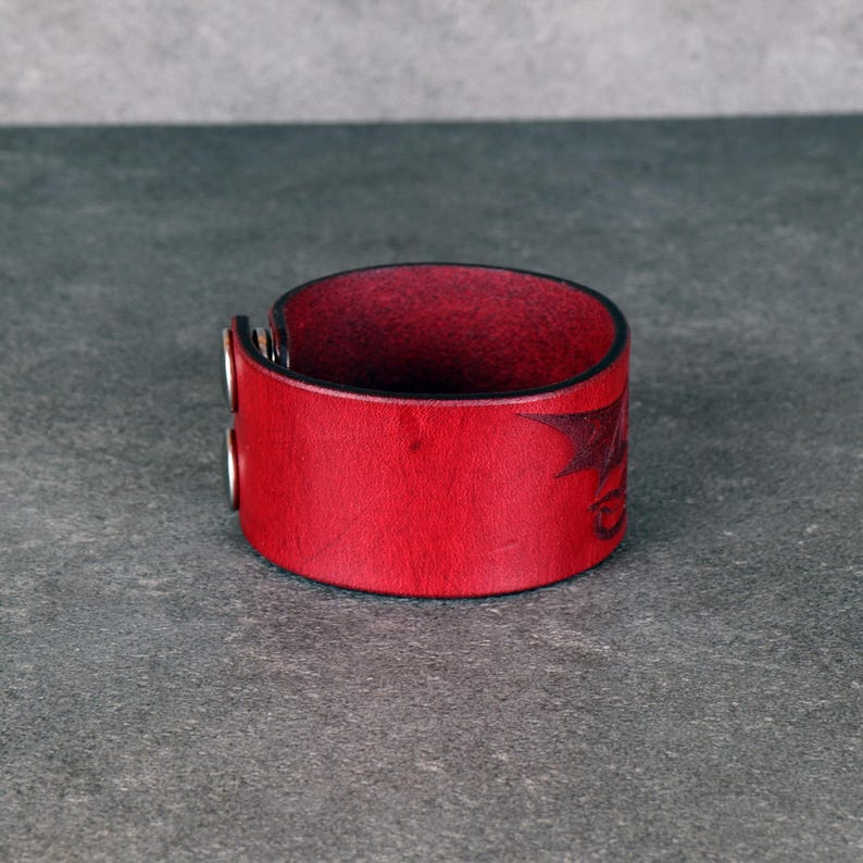 Handmade leather bracelet with dragon engraving.