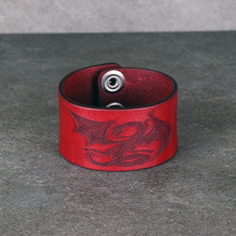 Handmade leather bracelet with dragon engraving.