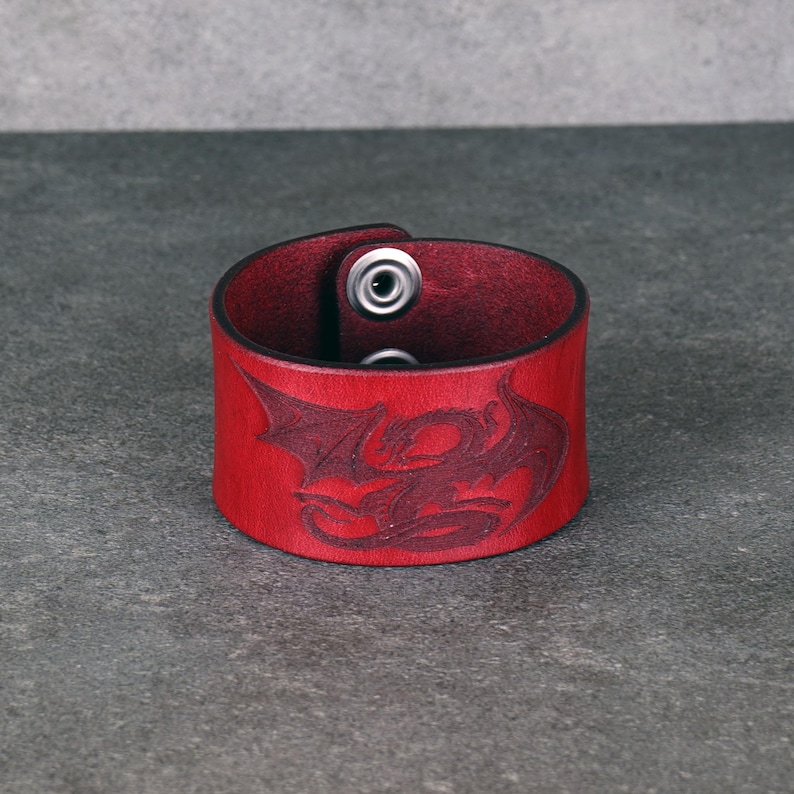 Handmade leather bracelet with dragon engraving.