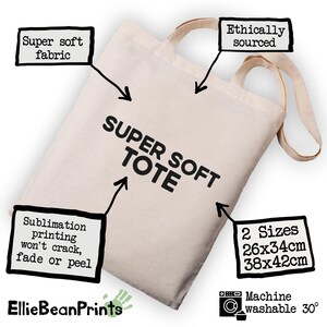 May include: A beige tote bag with the text "SUPER SOFT TOTE". The bag has two sizes: 10x13 inches and 15x16.5 inches. Features include super soft fabric, ethically sourced materials, and sublimation printing that won't crack, fade, or peel. Machine washable.