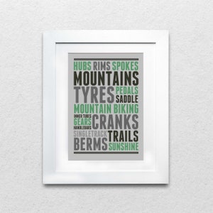 May include: A gray and green typography print with the words "Hubs, Rims, Spokes, Mountains, Tyres, Pedals, Saddle, Mountain Biking, Gears, Cranks, Single Track, Trails, Berms, Sunshine".