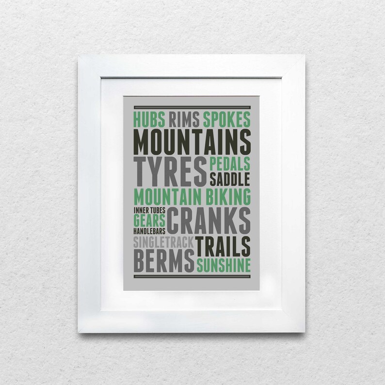 May include: A gray and green typography print with the words "Hubs, Rims, Spokes, Mountains, Tyres, Pedals, Saddle, Mountain Biking, Gears, Cranks, Single Track, Trails, Berms, Sunshine".
