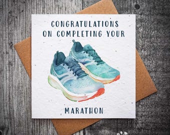 May include: A white card with a watercolour illustration of two blue running shoes. The card says "Congratulations on completing your marathon".