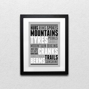 May include: Black and white typography print with the words "Hubs, Rims, Spokes, Mountains, Tyres, Pedals, Saddle, Mountain Biking, Inner Tubes, Gears, Cranks, Single Track, Trails, Berms, Sunshine"